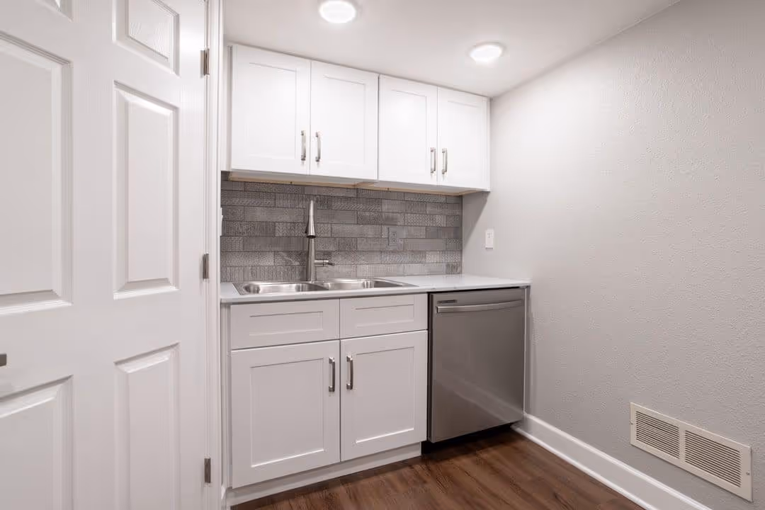 Laundry room renovation with functional cabinetry and a utility sink.