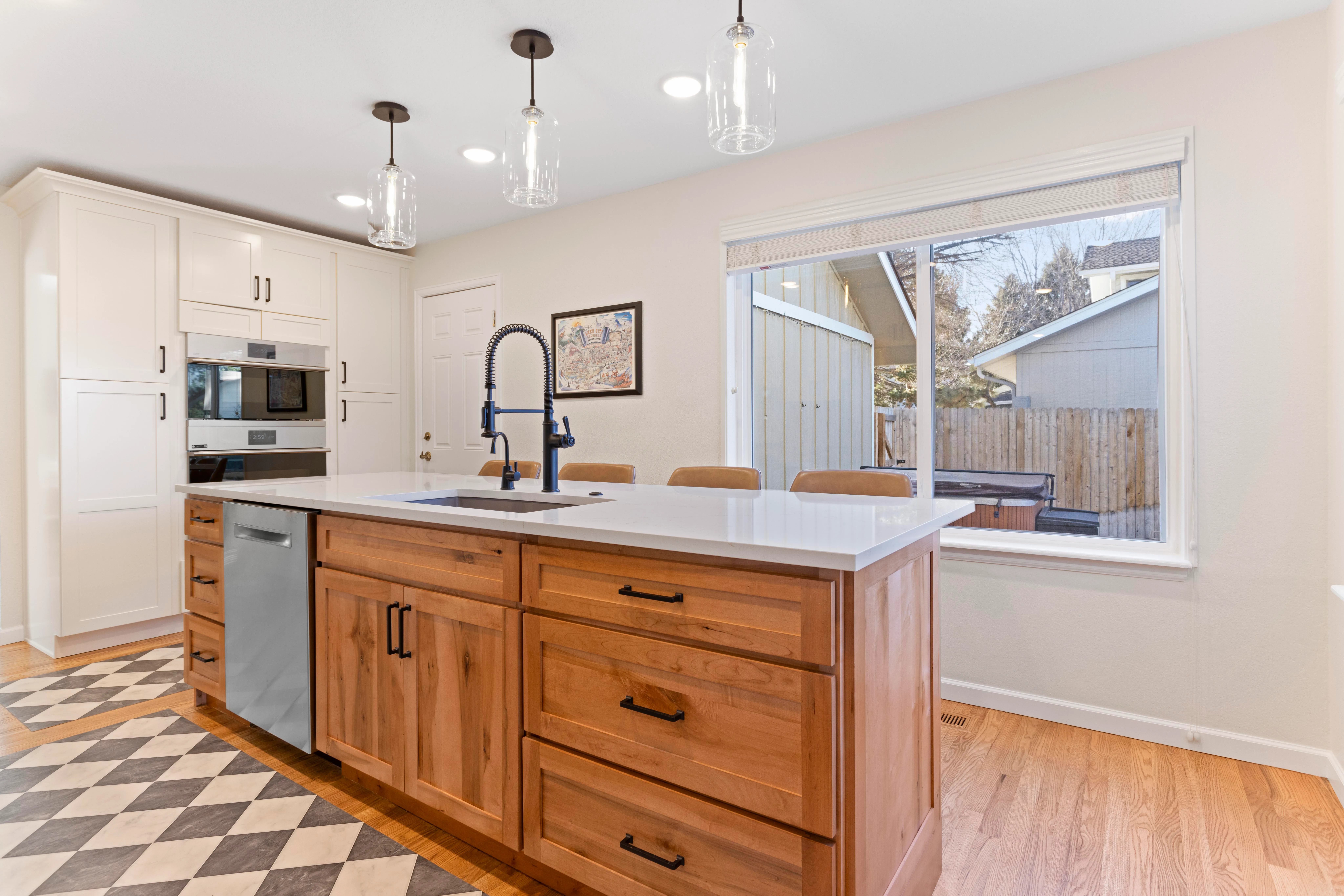 Beautifully refinished kitchen island with contrasting navy blue paint and brass hardware.
