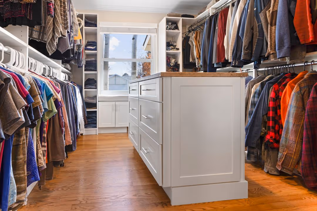 Custom organized closet system with hanging rods and shelving.