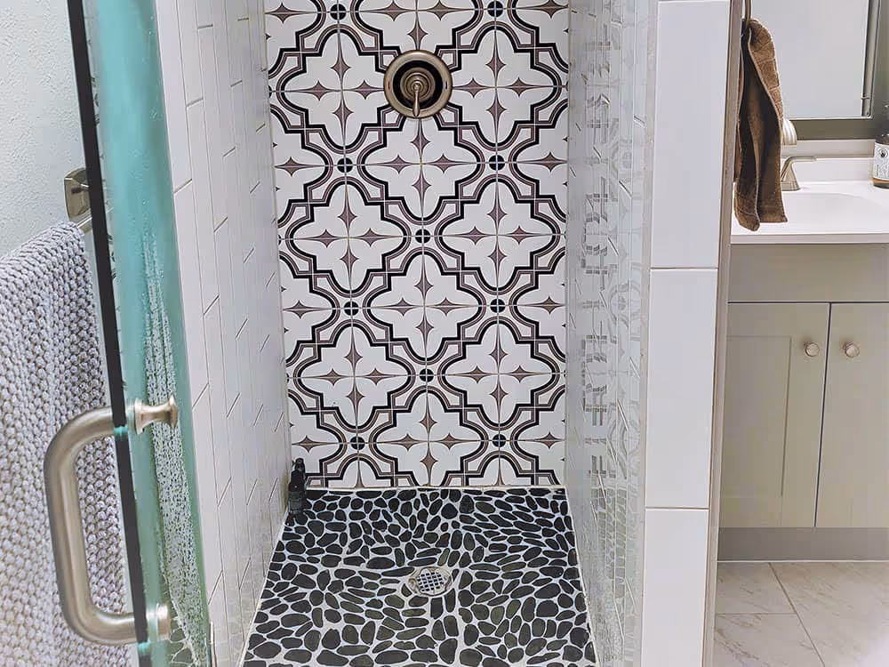 Detailed mosaic tile pattern in a bathroom shower or backsplash.
