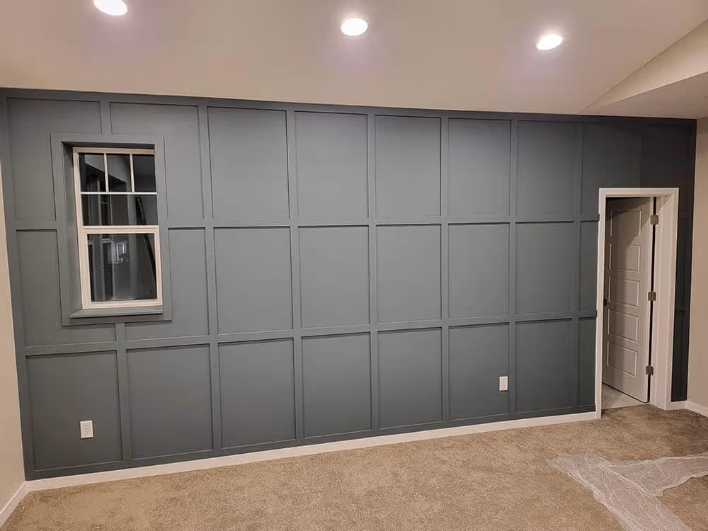 Accent wall with windows and built-in seating in a living space.