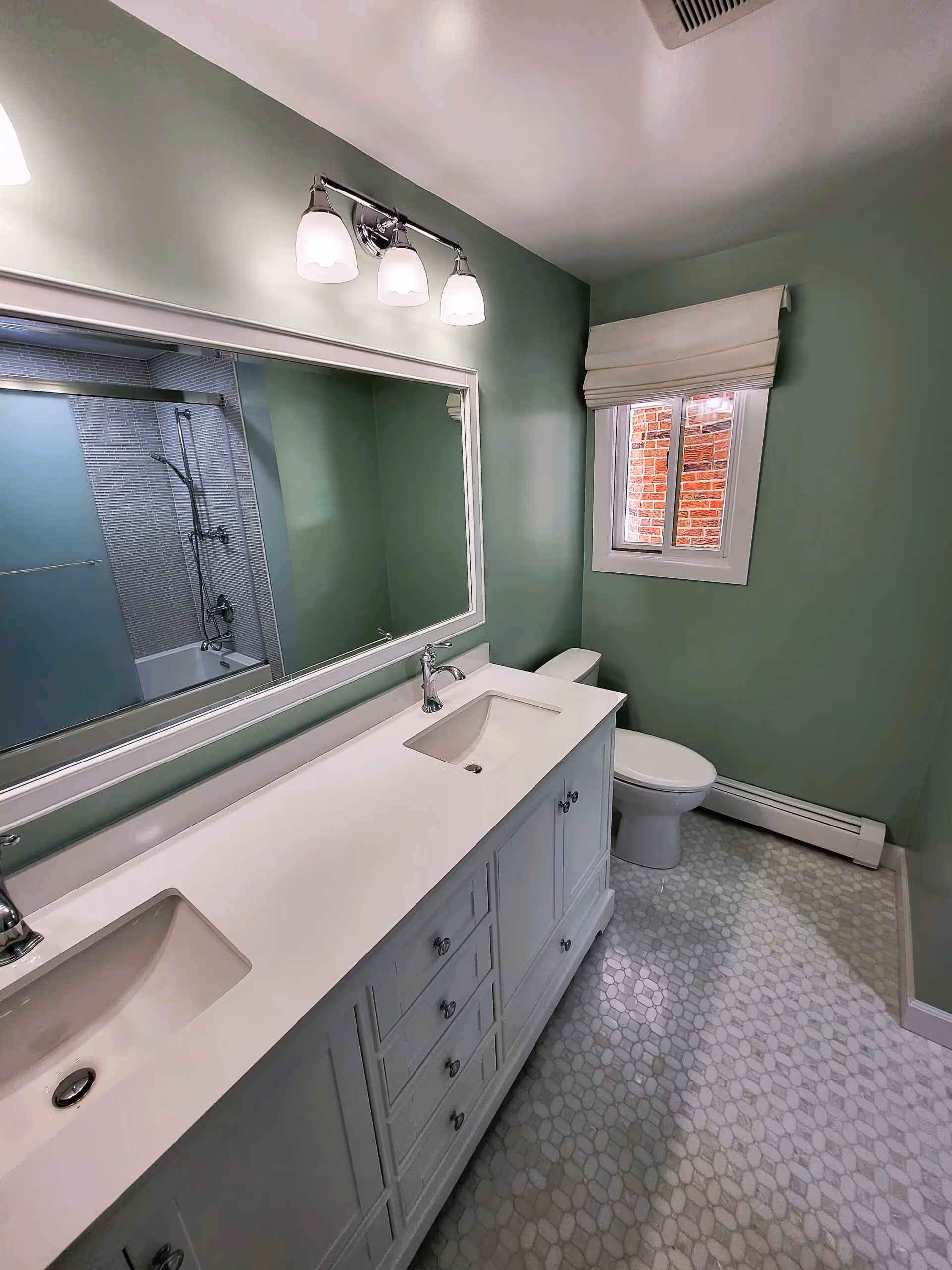 Bathroom with bold green cabinetry